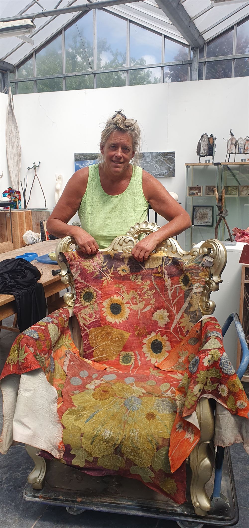 Marjo Wiltingh in haar atelier met een grote ecoprint over een stoel